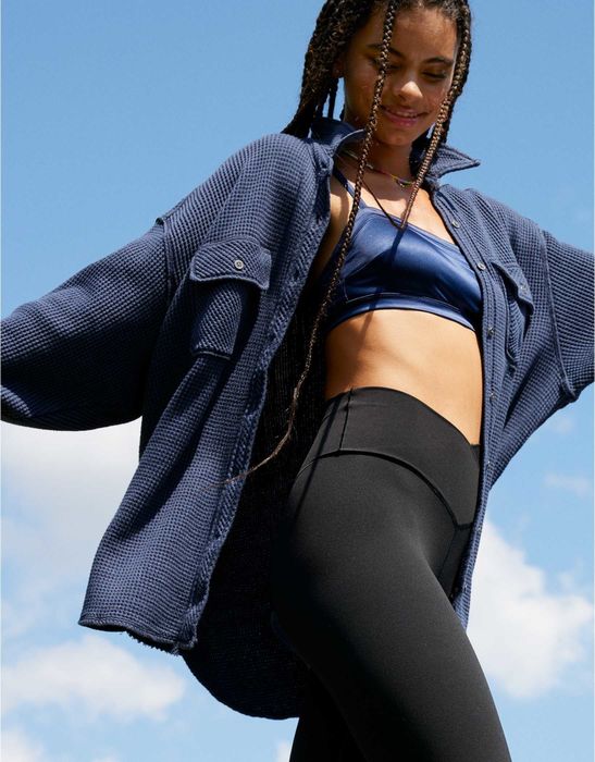 A model is showcasing the blue version of the button-up shirt.