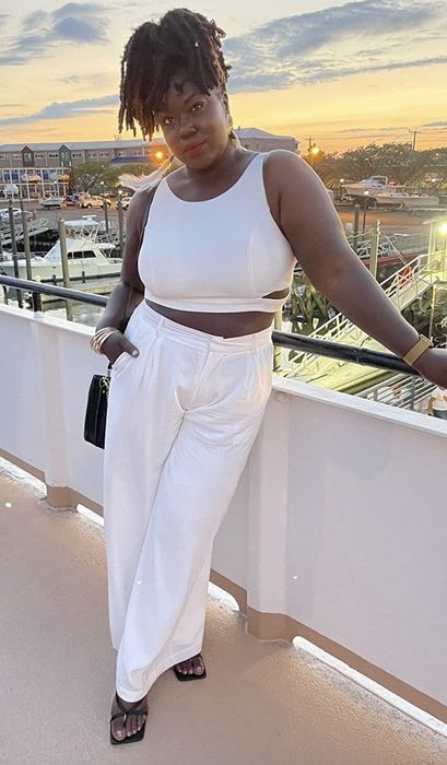 A reviewer is pictured wearing the pants.