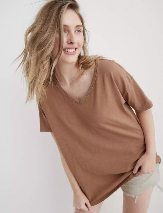 The model is wearing the brown tee.