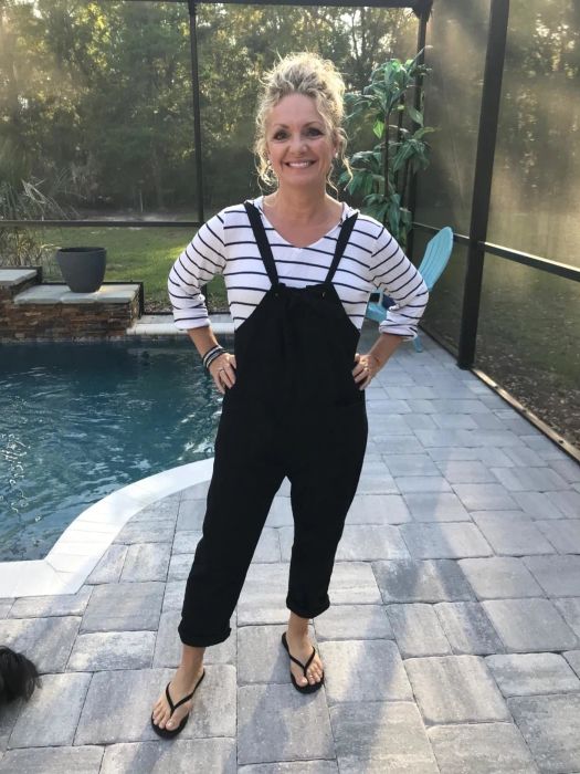 a reviewer photo of a customer wearing the black Aedvoouer Women's Jumpsuit near a backyard pool