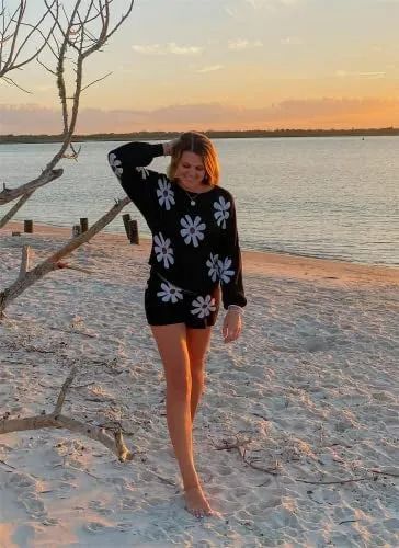 a model in a black two-piece set featuring white daisies