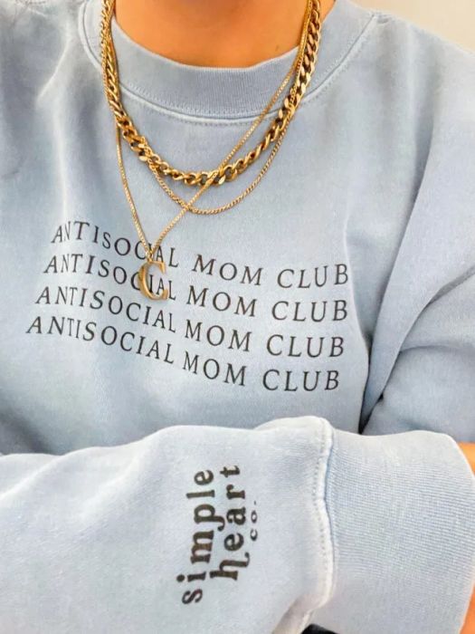 a model wearing a light blue sweatshirt with 