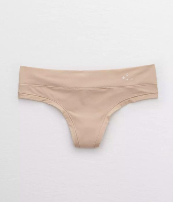 The beige thong featuring small silver stars at the top right corner of the waistband.