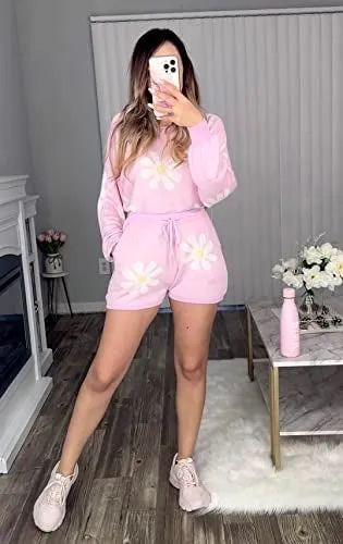 a model wearing a pink long-sleeve and shorts set featuring daisies