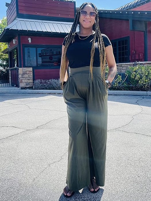 A reviewer is shown wearing the green-colored pants.