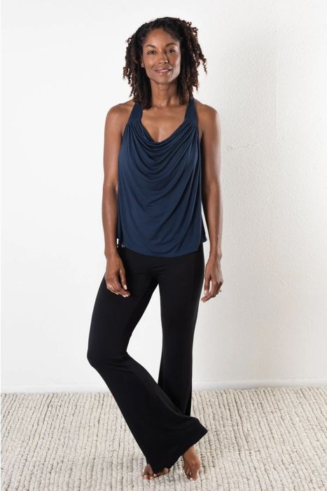 A model is pictured wearing black pants paired with a blue top.