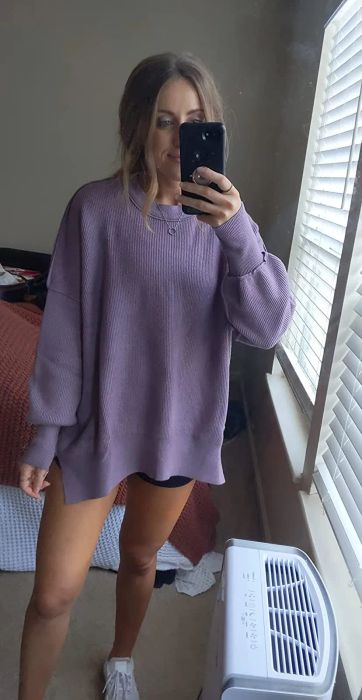 a reviewer wearing the purple sweater