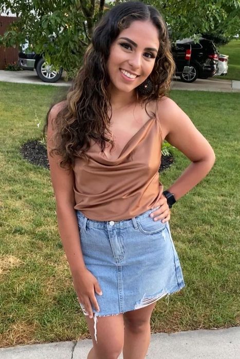 the top in brown styled with a denim skirt