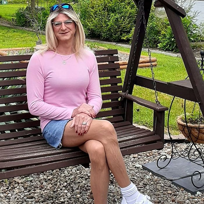 A reviewer showcasing the pink tee.