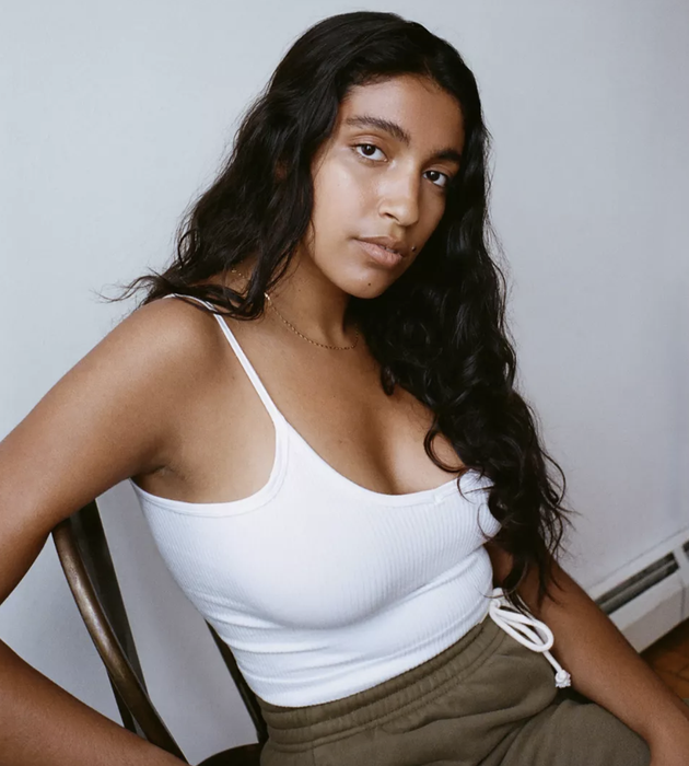 The model is wearing a white tank top.