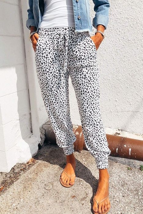 A model wearing the leopard-print drawstring pants in black and white