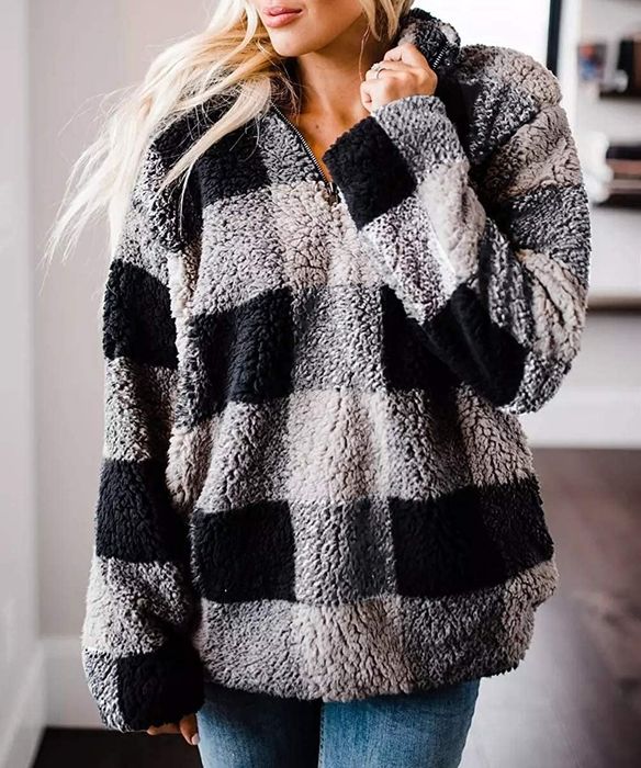 Model wearing a gray quarter-zip pullover from Zesica