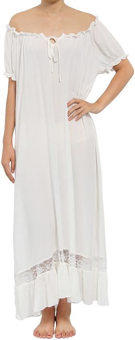 The model is dressed in a long white loose-fitting dress with delicate lace trim.