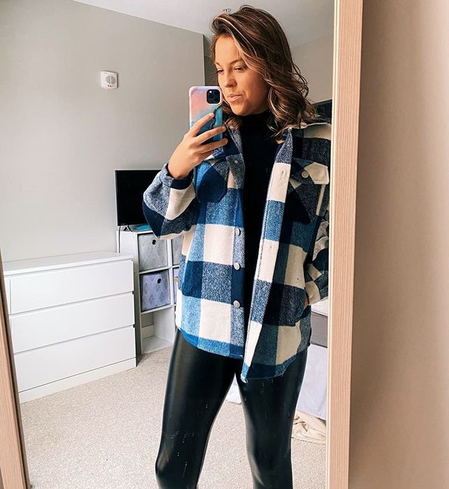 A reviewer sports a blue and white plaid shacket.