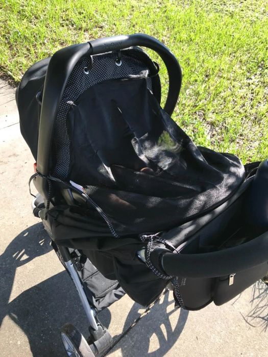 Reviewer's photo of the sun shade attached to a stroller, offering complete sun protection