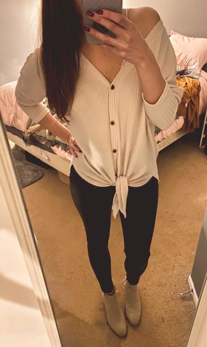 Amazon reviewer modeling the white waffle-knit tie-front tunic
