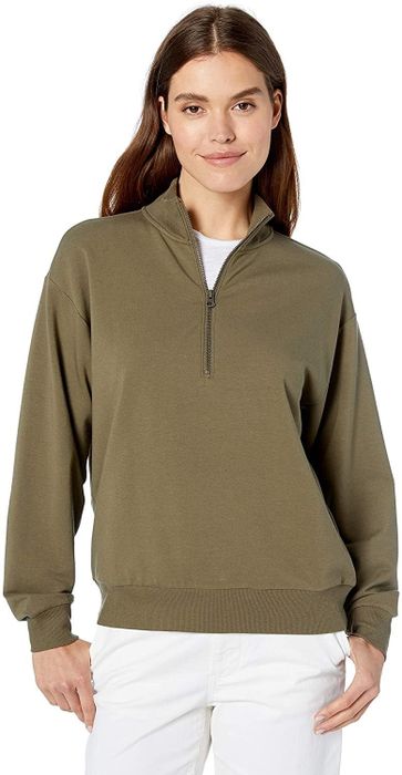 The model is sporting an olive green sweater.