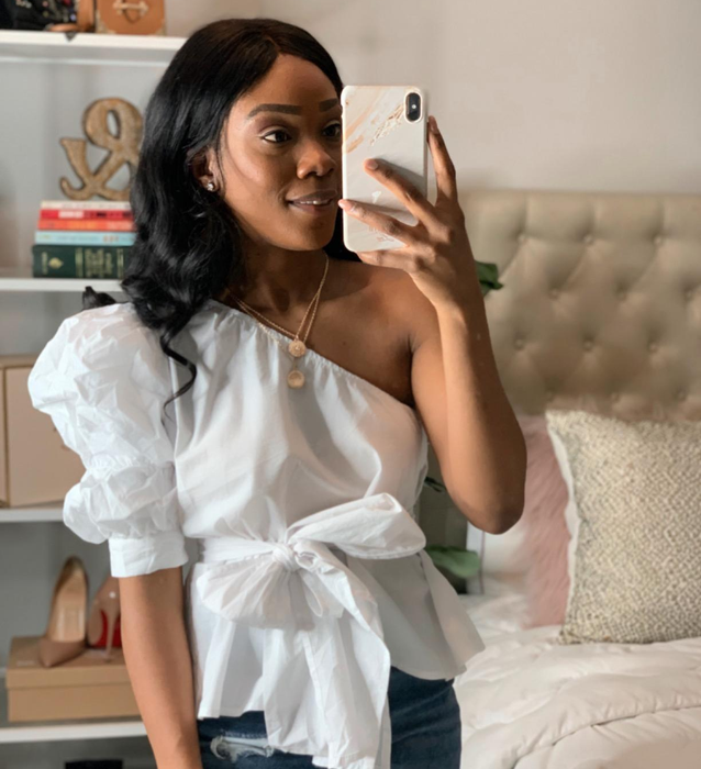 reviewer styled in the white top paired with blue jeans