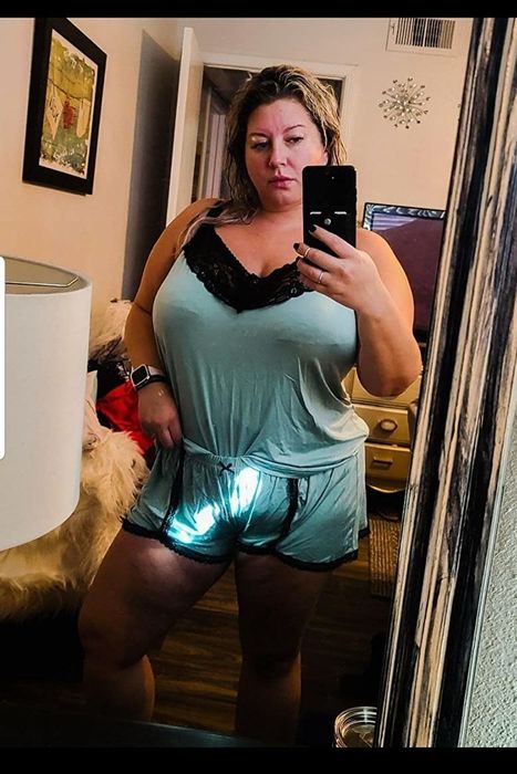 A reviewer wearing the mint-colored set with black lace detailing