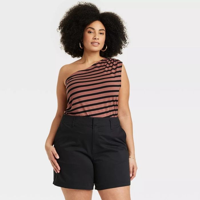 Model wearing the brown one-shoulder top with black stripes