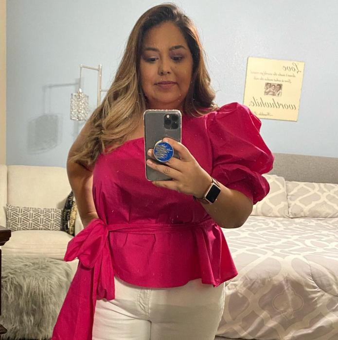 a second reviewer showcasing the pink belted top