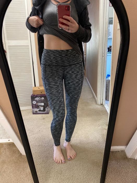 Reviewer modeling leggings in a space dye gray shade