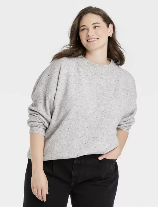 The model is sporting a gray mock turtleneck.