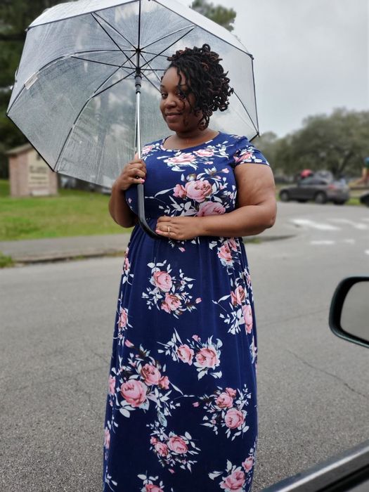 Reviewer wearing a navy floral print short-sleeve dress