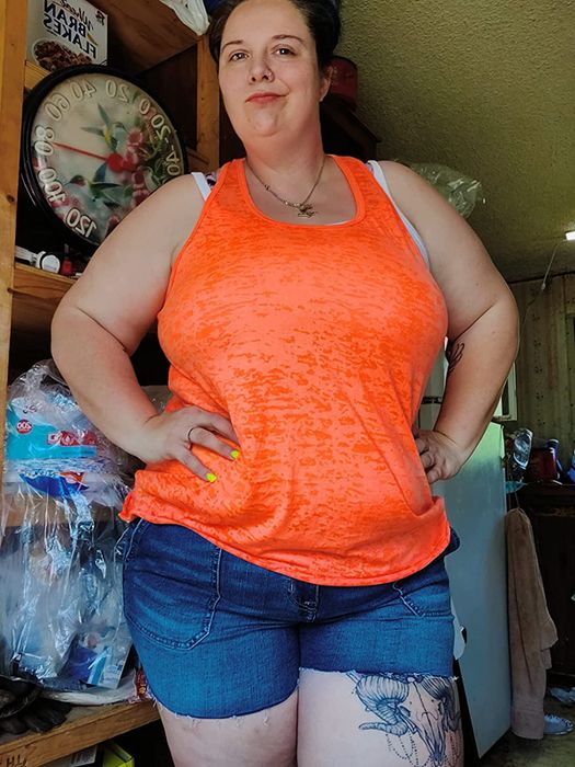 Image of a reviewer wearing an orange tank