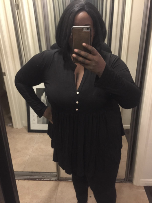 The reviewer is styled in a black V-neck button-up top.