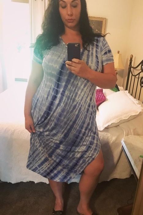A reviewer showcasing the blue and white version, holding it to highlight the side slits