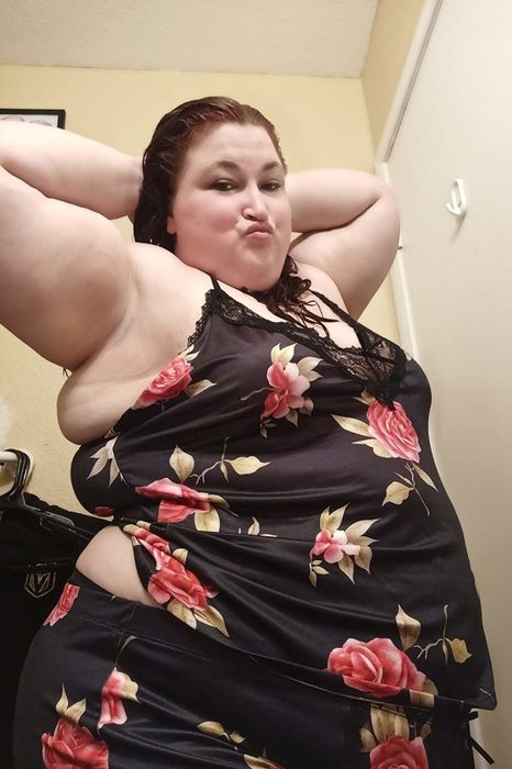 A reviewer wearing the black floral print version