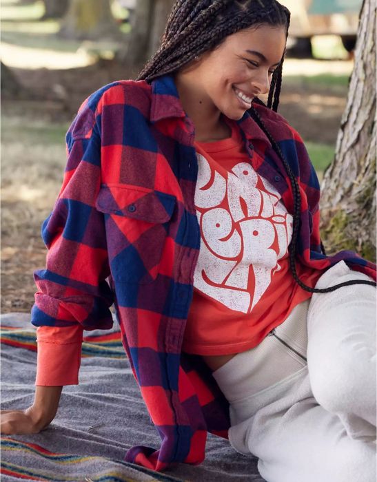 Model wearing a red plaid shirt