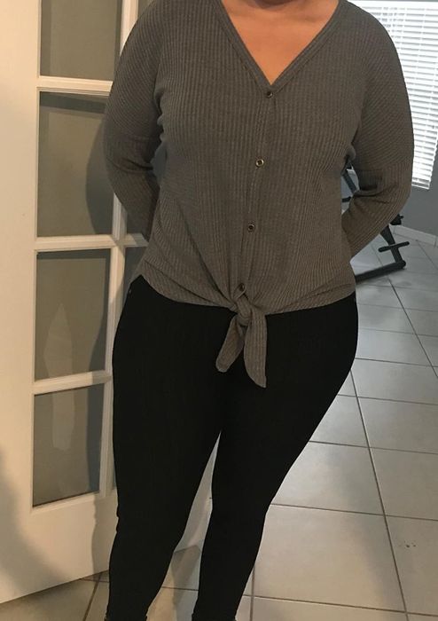 Amazon reviewer pictured in the gray waffle-knit tie-front tunic