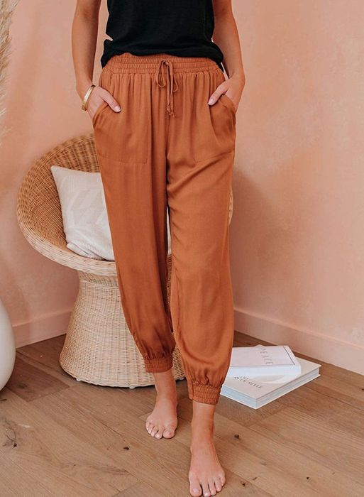 A model showcasing the vibrant orange pants