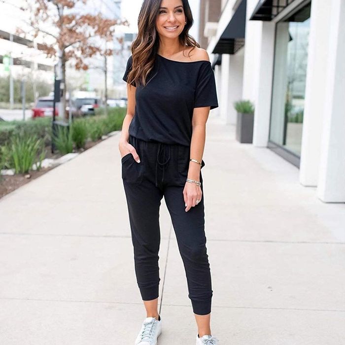 Model showcasing a black off-the-shoulder jumpsuit