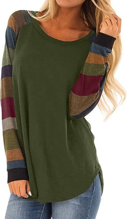Model wearing a green tunic with multicolor striped sleeves