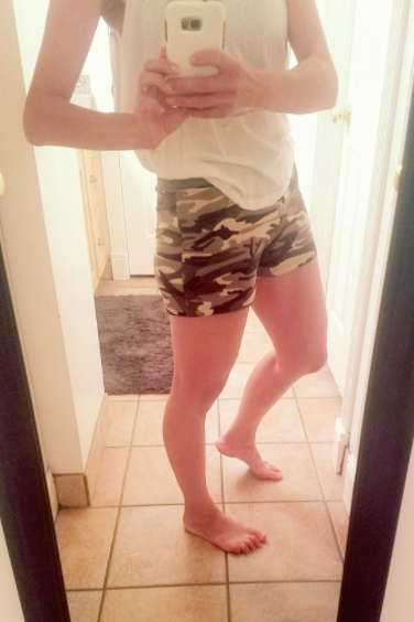 A reviewer wearing the camouflage-patterned shorts
