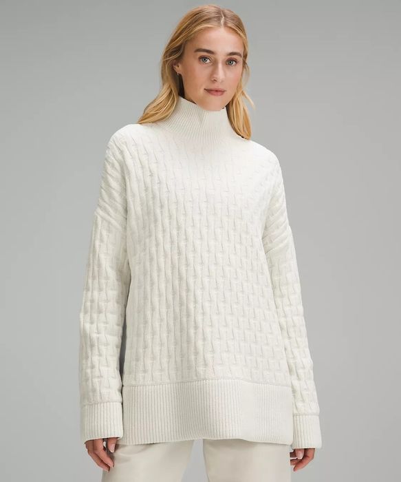 white knitted sweater worn by a model