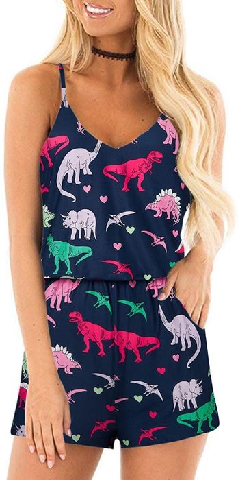 A model wearing the navy romper featuring a dinosaurs and hearts print