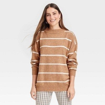 The model is wearing a tan and white striped sweater.