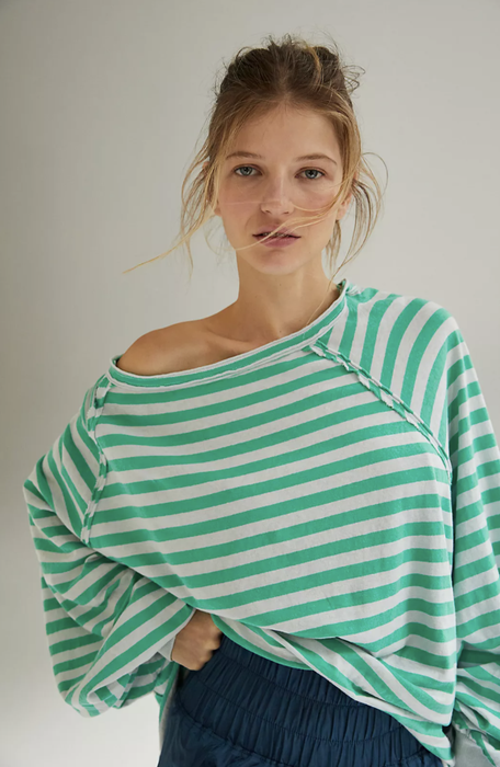 Model photographed in a green striped top by Free People Movement