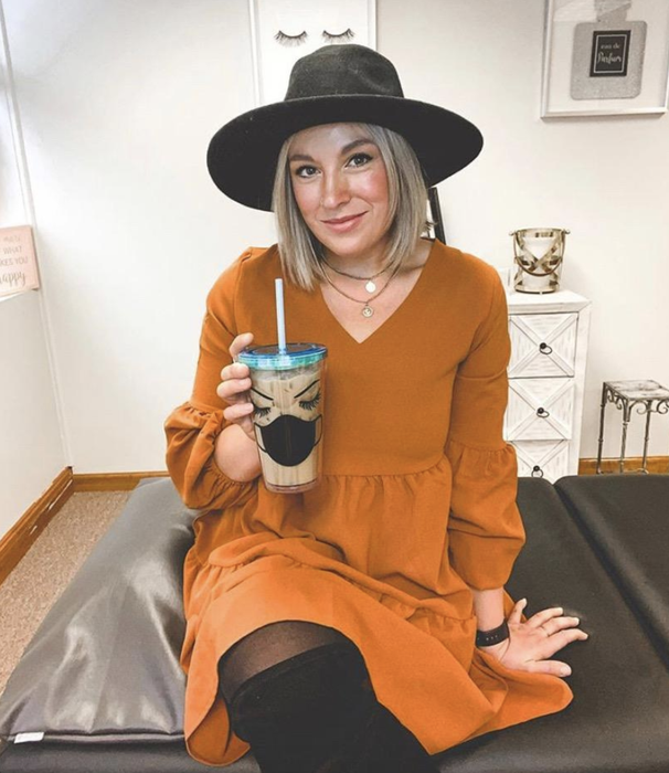 reviewer sporting the orange dress