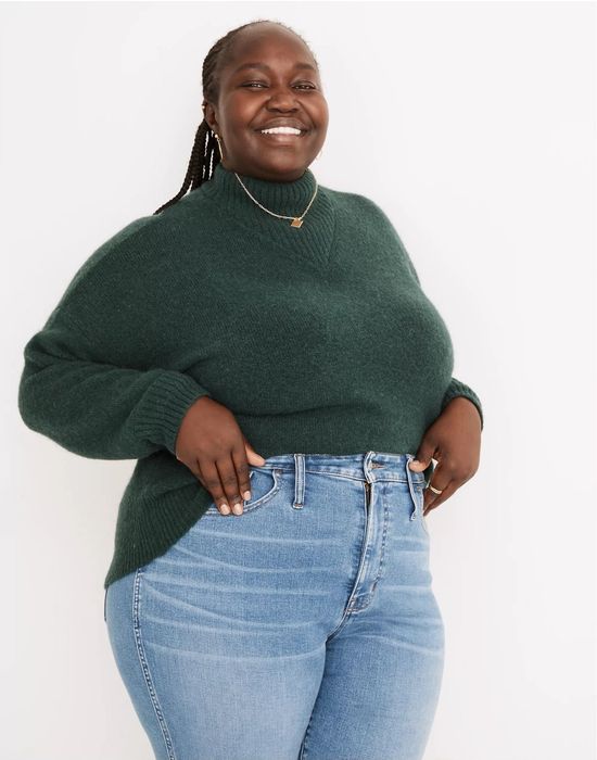 Model wearing the dark green pullover.