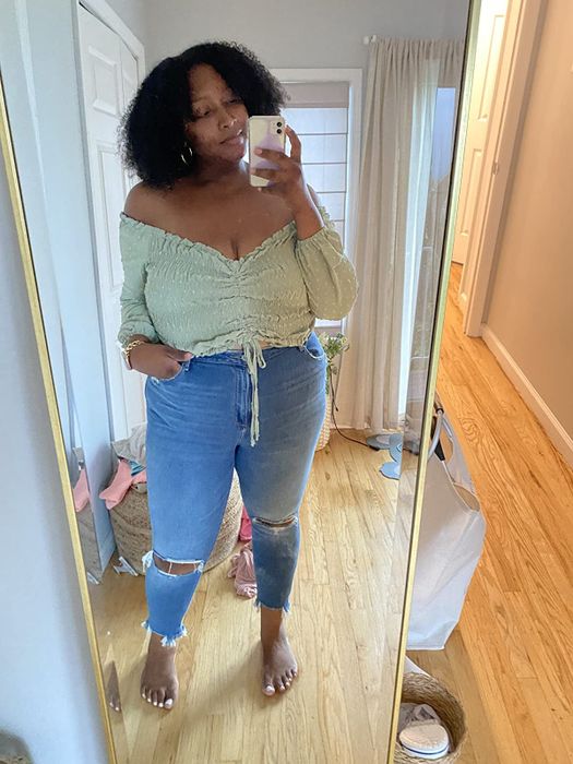 a reviewer wearing the green version with the top fully cropped