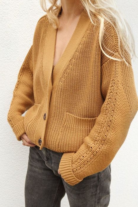 Model wearing the caramel-colored sweater.