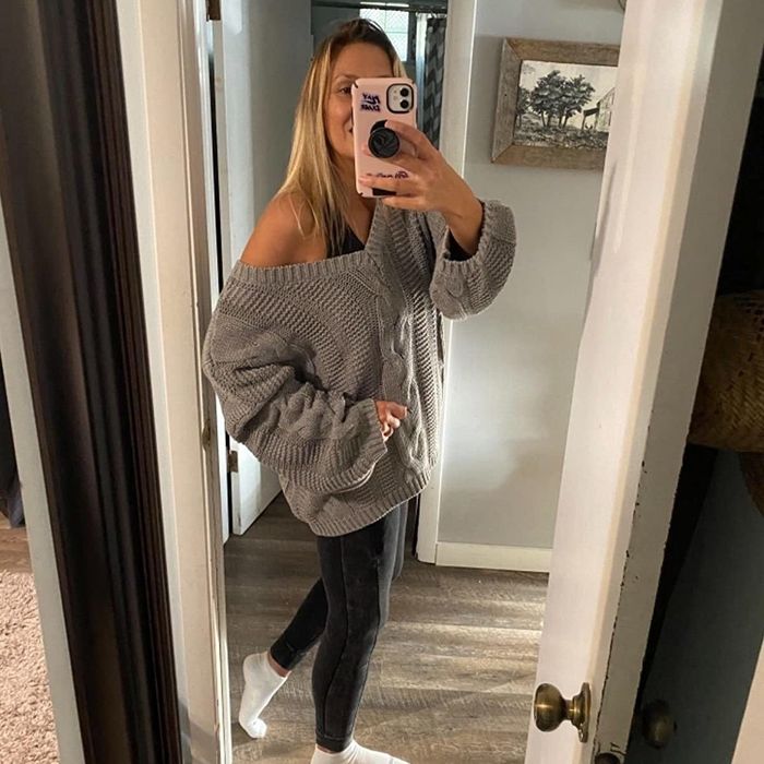 Reviewer styled in a gray Astylish cable-knit sweater