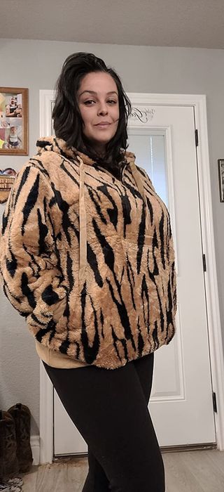 A reviewer styled a black and tan tiger-print hoodie with black pants, creating a bold yet comfy look.