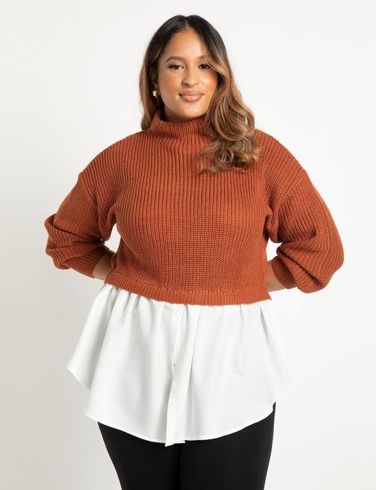 The model is wearing a two-part sweater with an orange knit top and a white button-down section peeking out from the bottom.