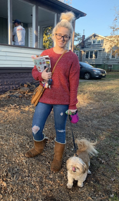 A reviewer is seen in the same burgundy sweater with white heart details.